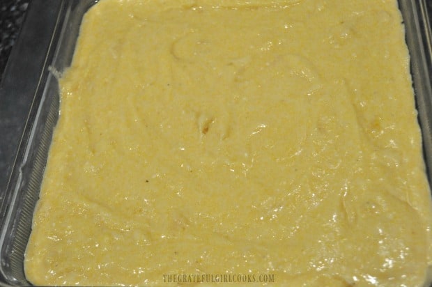 Cornbread batter is poured into a 9x9 inch baking dish.