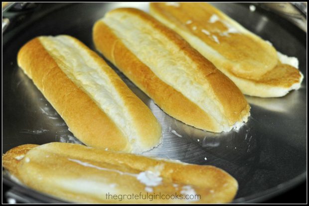 Grilling hoagie rolls in skillet, for BBQ shredded pork hoagies.