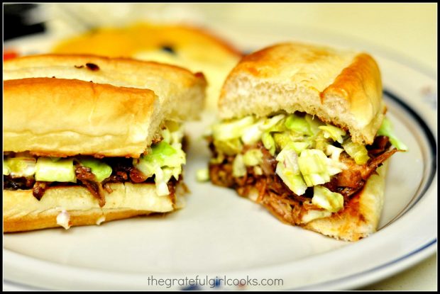 BBQ shredded pork hoagies, cut in half on a plate