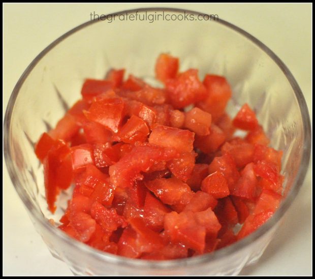 Roma tomatoes are diced for adding to wedge salad.