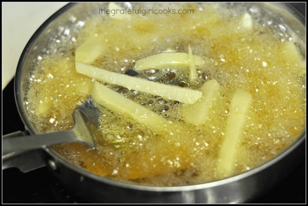 Potatoes cook in hot oil for 8 minutes
