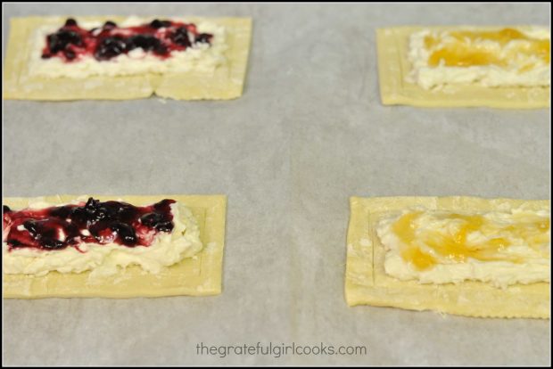 Jam is added to each fruit and cheese danish before baking.