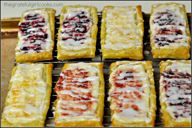 A vanilla glaze is drizzled over the baked fruit and cheese pastries before serving.