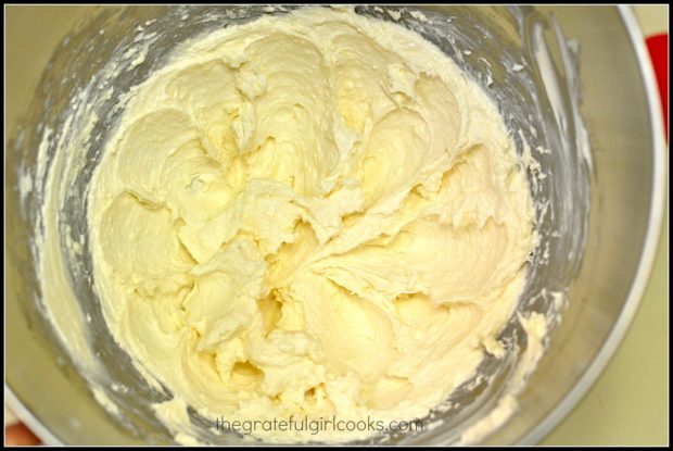 Cream cheese filling in bowl, used for apple cream cheese pastries.