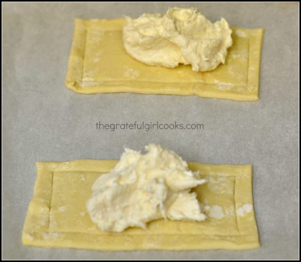 Spoonfuls for cream cheese filling are placed onto middle of dough.