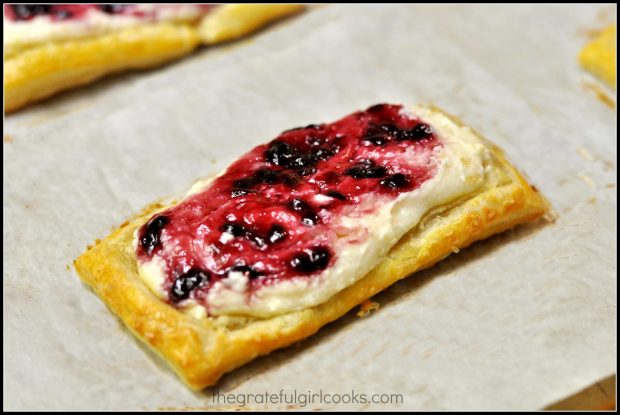 An up close look at a boysenberry fruit and cheese danish.