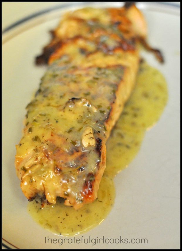 Finished salmon fillet, with lemon herb butter sauce on top