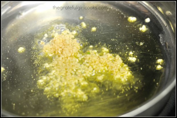 Minced garlic is quickly cooked in hot oil before adding other ingredients.