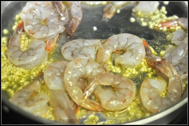 Shrimp is added to the skillet with the cooked garlic and oil.