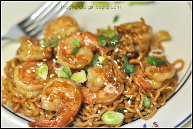 A serving of shrimp and noodles in spicy garlic sauce on a plate, ready to be enjoyed.