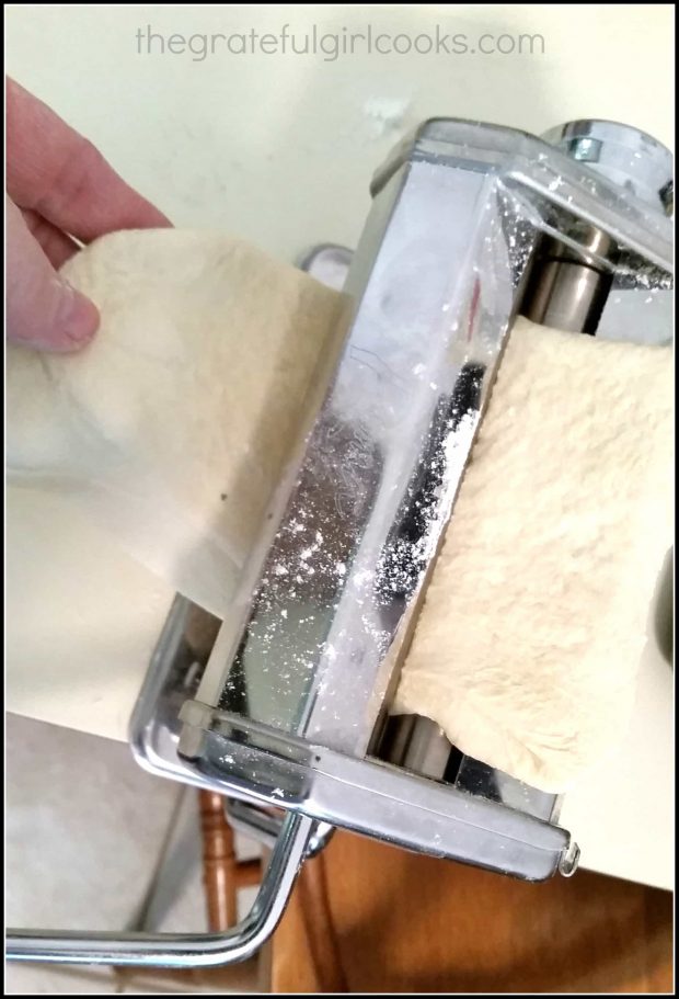 A pasta machine is used to make long sheets of dough for the ravioli.