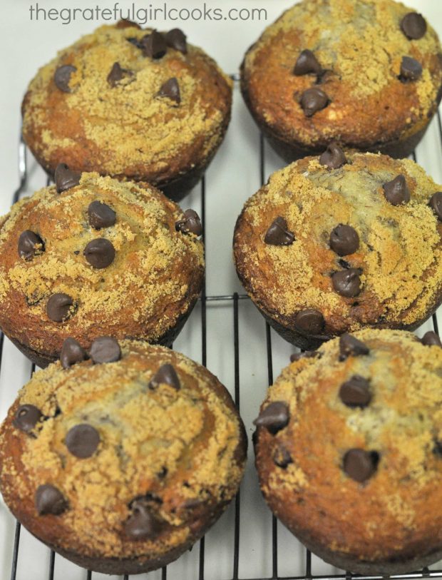 After baking, the chocolate chip banana muffins cool on a wire rack before glazing.