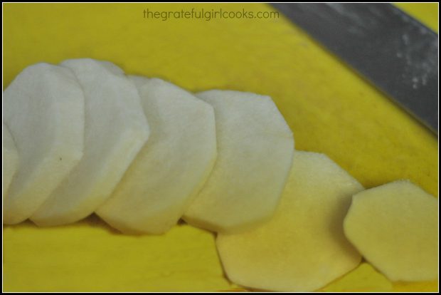 Raw jicama is sliced then cut into cubes for Southwestern cobb salad.