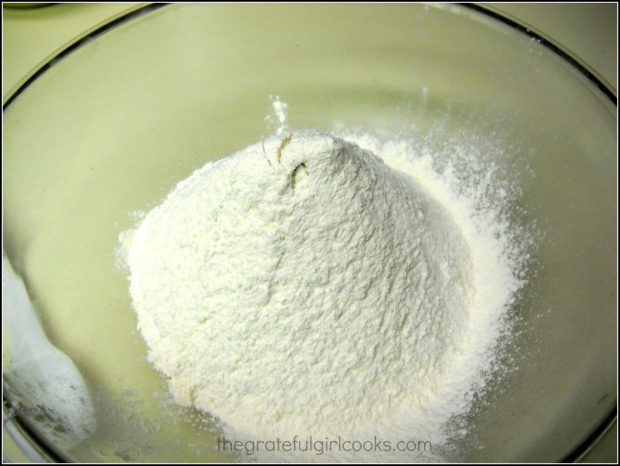 Flour and baking soda in bowl, for dough to make Spring flower sugar cookies.