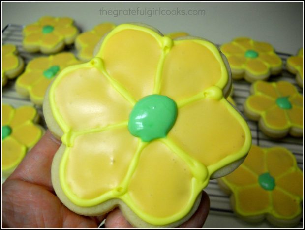 Green icing added to center of one of the Spring flower sugar cookies.