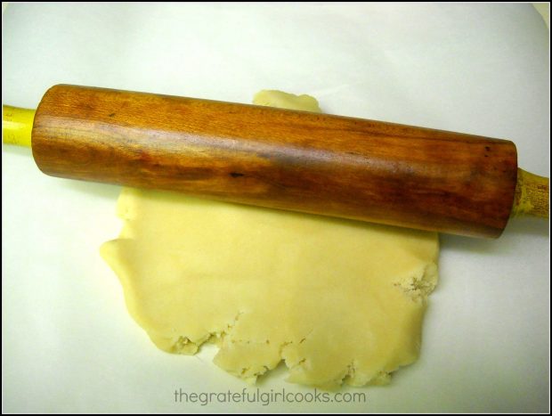 Dough for the Spring flower sugar cookies is rolled out before cutting.