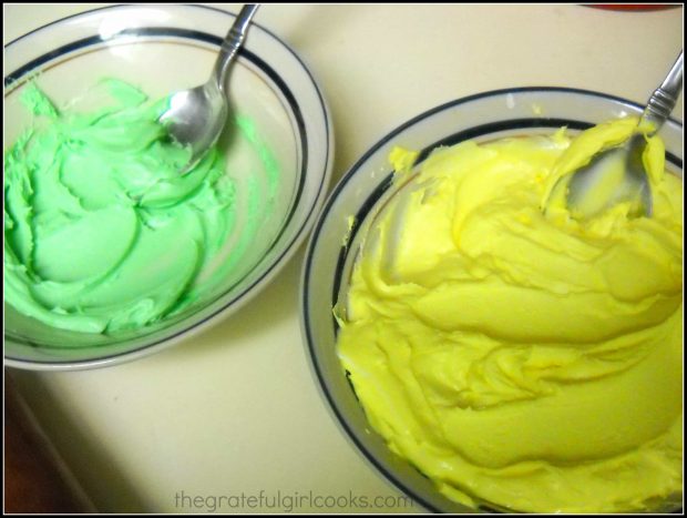 Yellow and green royal icing in bowls, to decorate Spring flower sugar cookies.