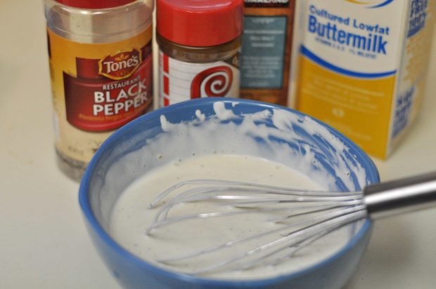 Ingredients for bleu cheese dressing are whisked together in blue bowl.