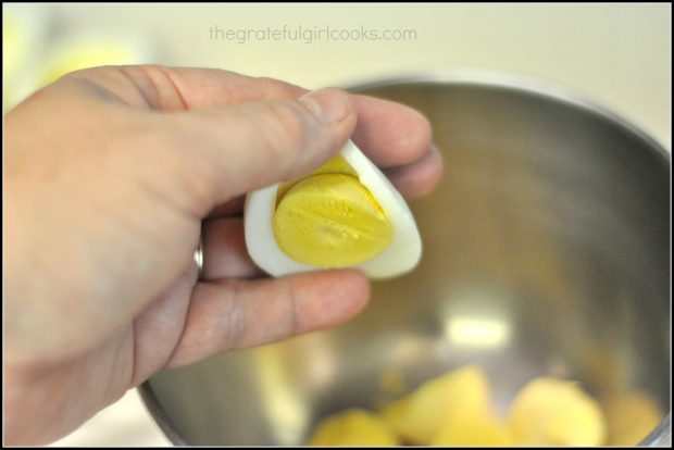 Removing egg yolk from hard boiled egg