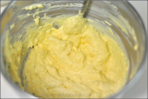 Egg yolks, mayo and mustard mixed together in silver mixing bowl