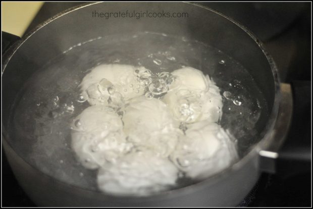 Eggs boiling in water in pan