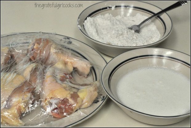 Chicken, flour and buttermilk on counter