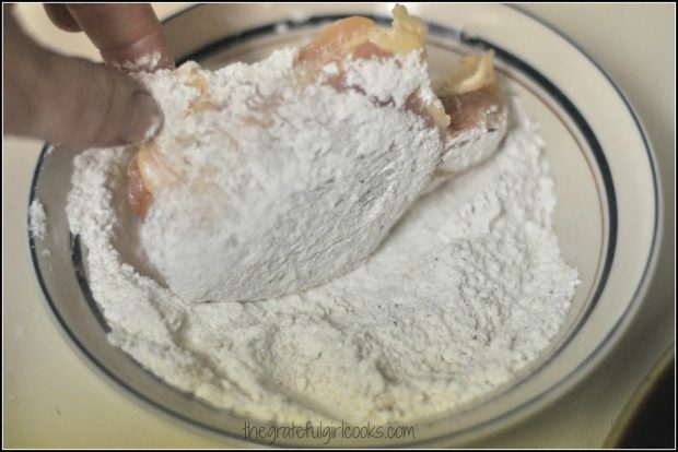 Chicken dipped in flour in bowl