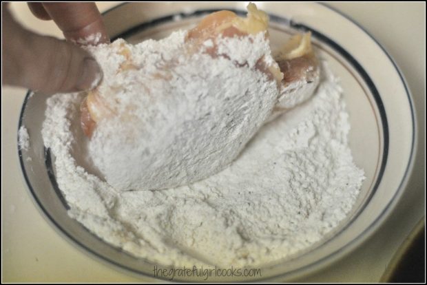 Chicken dipped in flour in bowl