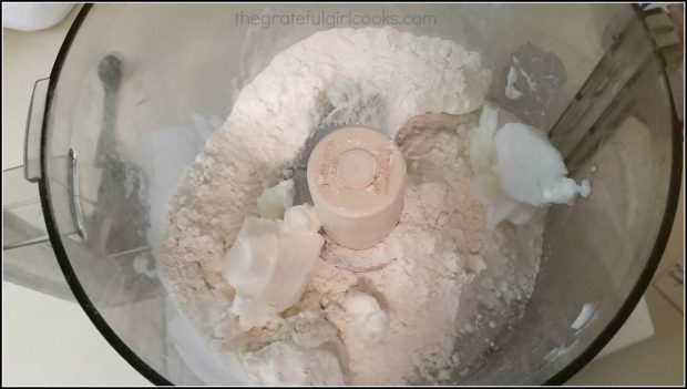 Flour, salt, and shortening in a food processor to make pie crust dough.