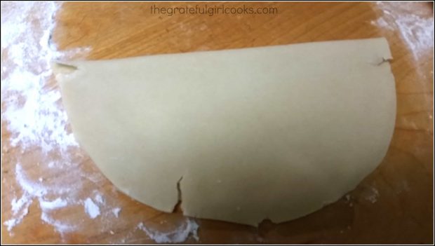 Crust dough is folded in half for transferring to pan.
