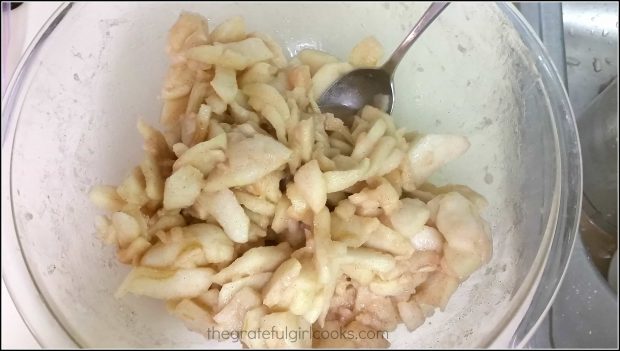 Dutch crumb apple pie filling is mixed in a large bowl.