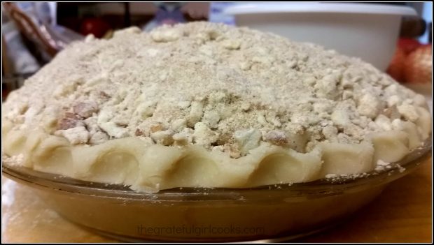 A side view to see the topping piled up on the Dutch crumb apple pie before baking.