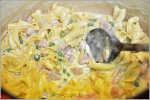 The cooked, drained egg noodles are then added to the ham, peas and cheese sauce.