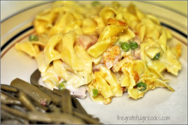 A portion of the pasta, ham and Gruyere casserole with green beans on the side.