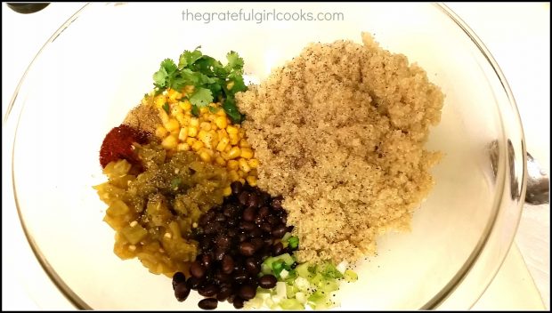 Cooked quinoa and other ingredients for casserole in mixing bowl.