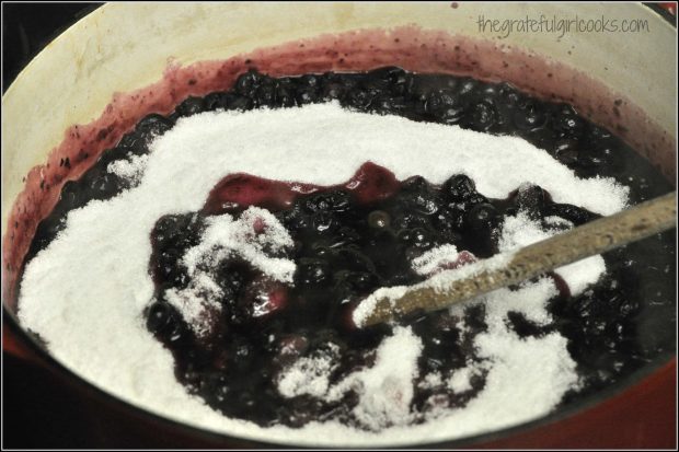 Sugar is added to blueberry jam mixture