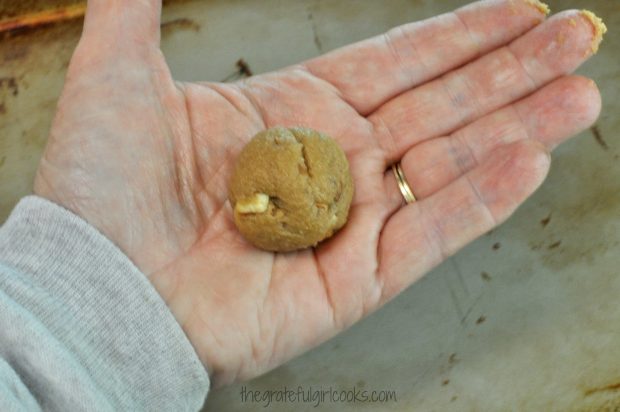 The cookie dough for butter pecan crisps is rolled into small balls before baking.