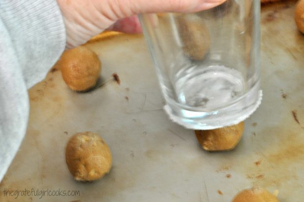 Butter pecan crisps are flattened with sugar coated bottom of glass cup before baking.