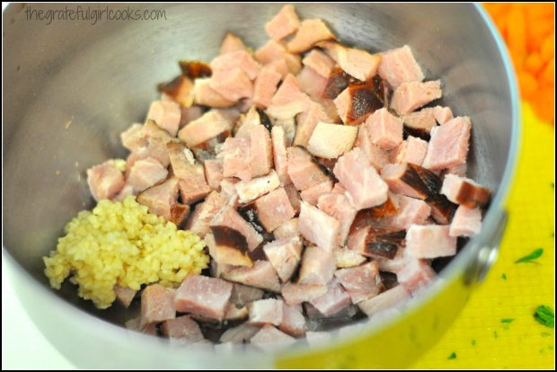 Chopped ham and minced garlic for soup, in metal bowl
