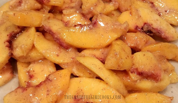 Fresh peach pie filling is added to unbaked pie crust before baking.