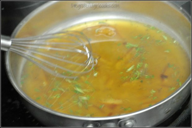 Sticky orange sauce is mixed, and begins to thicken as it cooks.