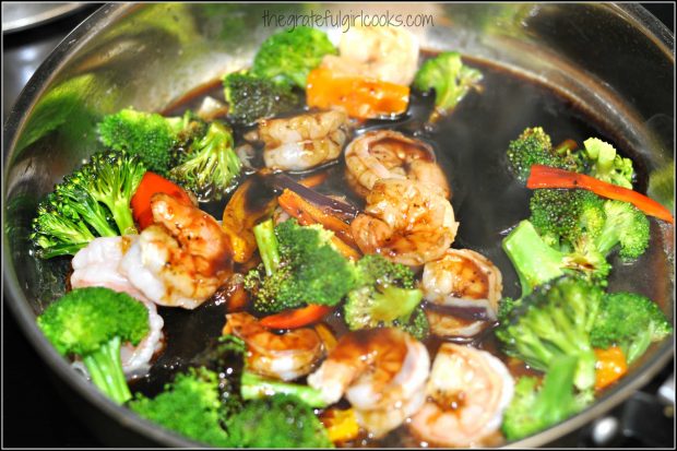 Asian glazed shrimp and veggies cooking in sauce.