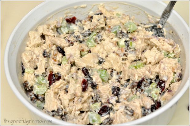 Ingredients are mixed with condiments and seasoning to make chicken salad.