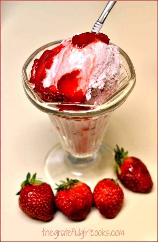Homemade strawberry ice cream, in dish with strawberry topping