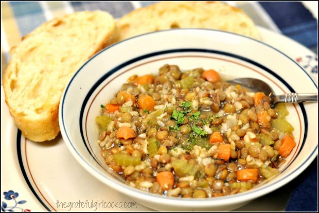 Lentil Stew in bowl, with garlic bread on side