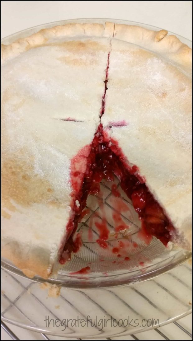 Slice of pie is removed to show raspberry-peach melba pie filling.