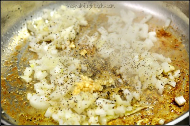 Onions and garlic used in pork paprikash sauce, cooking in skillet.