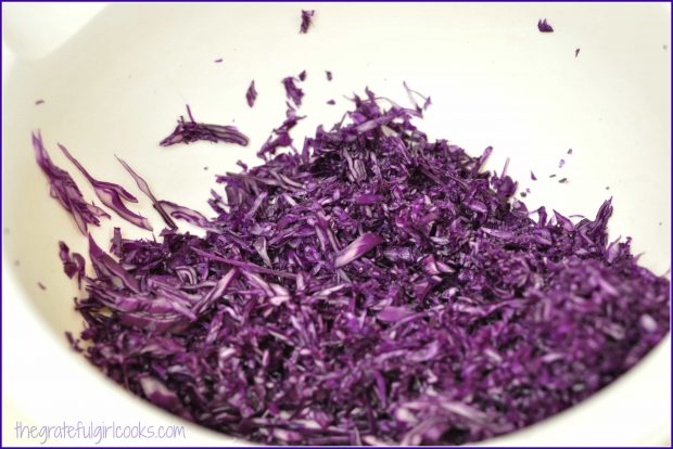 Shredded purple cabbage in bowl.