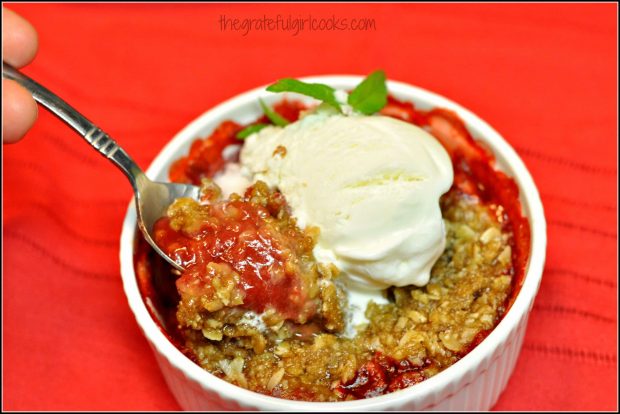 Spoonful of fruit cobbler, with ice cream