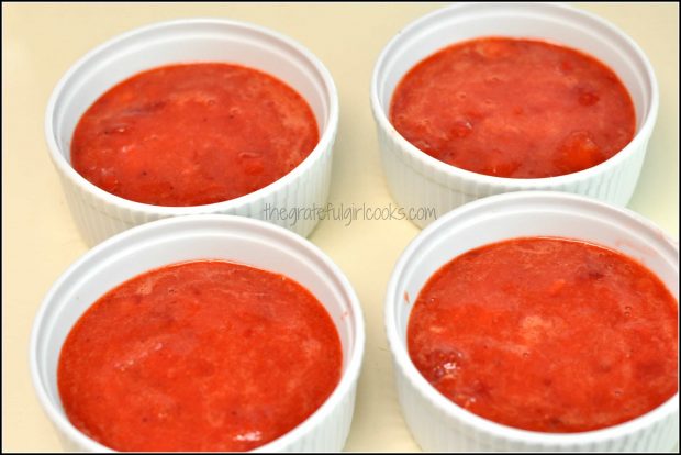 Strawberry filling divided into 4 white ramekins for cobbler